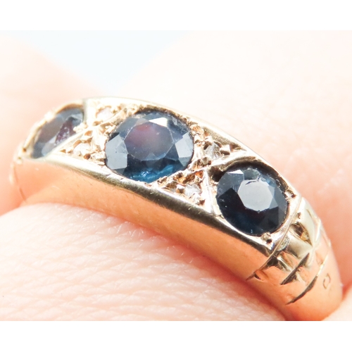 301 - Sapphire Three Stone Ring with Diamond Insets Mounted in 18 Carat Yellow Gold Ring Size Q