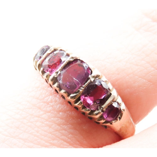 328 - Pink Garnet Five Stone Graduated Form Ring Mounted in 9 Carat Yellow Gold Ring Size M and a Half