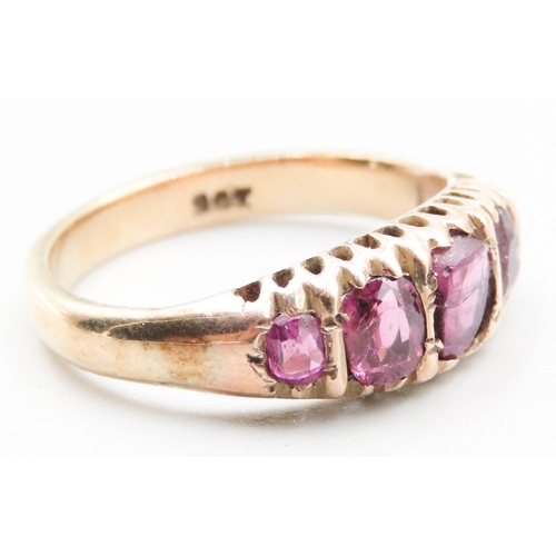 328 - Pink Garnet Five Stone Graduated Form Ring Mounted in 9 Carat Yellow Gold Ring Size M and a Half