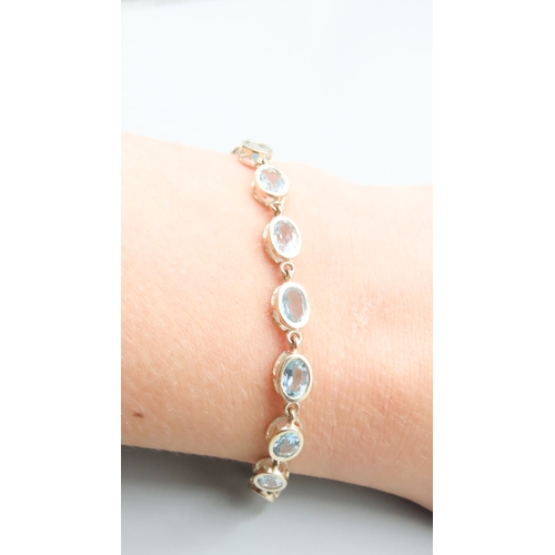 371 - Fifteen Stone Sky Blue Topaz Bezel Set Bracelet Mounted in 9 Carat Yellow Gold 19.5cm Long