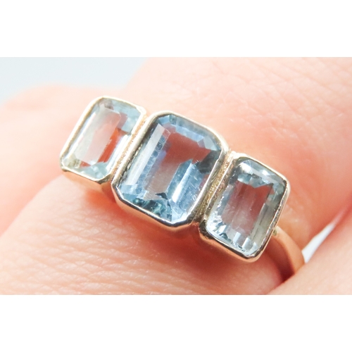 383 - Three Stone Bezel Set Sky Blue Topaz Ring Mounted in 9 Carat Yellow Gold Ring Size N