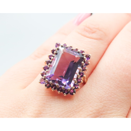 384 - Emerald Cut Amethyst Ring Set with Amethyst Halo Surround Mounted in 9 Carat Yellow Gold Ring Size O... 