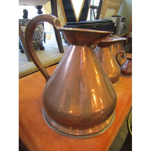 1040 - Set of Five Copper Measuring Jugs Graduated Sizes