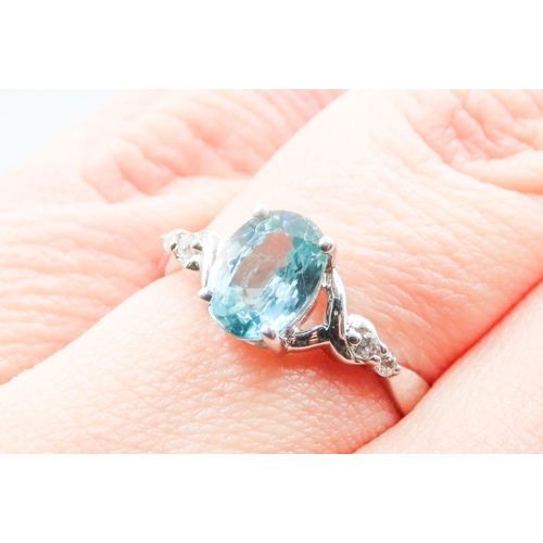 141 - Blue Topaz Set Ring with Gemstones Set to Shoulders Mounted in 10 Carat White Gold Ring Size O