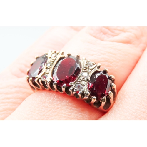 168 - Red Garnet Three Stone Ring Mounted in 9 Carat Yellow Gold Gemstone Insets Ring Size N