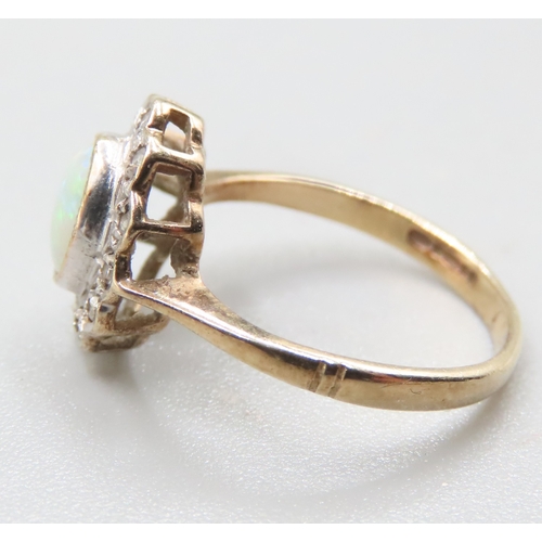 197 - Attractively Detailed Opal Bezel Set Centre Stone Ring with Diamond Set Halo Mounted in 9 Carat Yell... 