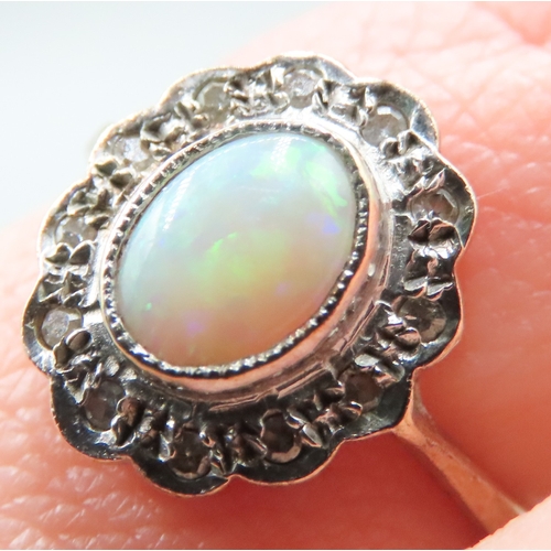 197 - Attractively Detailed Opal Bezel Set Centre Stone Ring with Diamond Set Halo Mounted in 9 Carat Yell... 