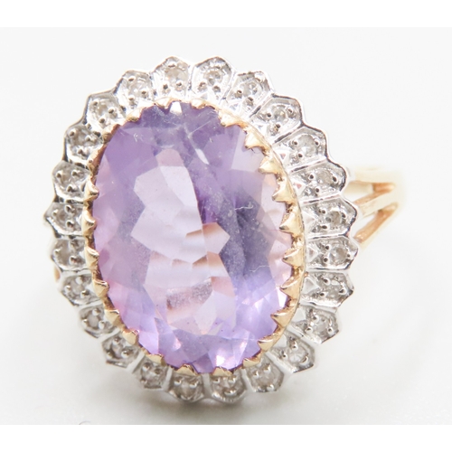 212 - Attractively Detailed Oval Cut Amethyst Centre Stone Ring with Diamond Set Halo Surround Mounted in ... 