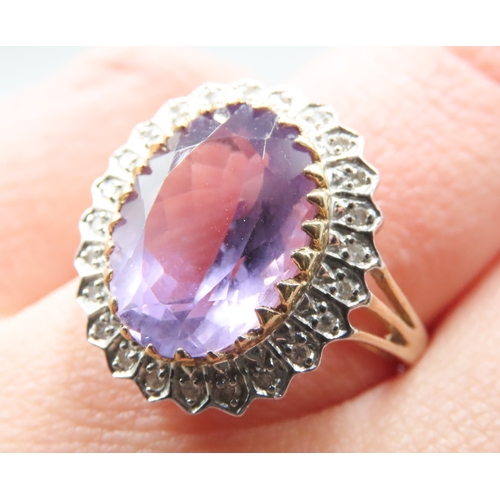 212 - Attractively Detailed Oval Cut Amethyst Centre Stone Ring with Diamond Set Halo Surround Mounted in ... 