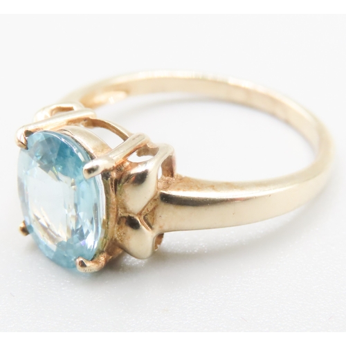 214 - Blue Topaz Single Stone Bow Motif Ring Mounted in 9 Carat Yellow Gold Ring Size O