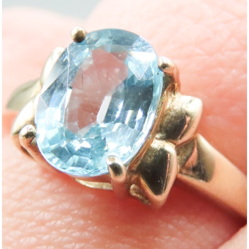 214 - Blue Topaz Single Stone Bow Motif Ring Mounted in 9 Carat Yellow Gold Ring Size O