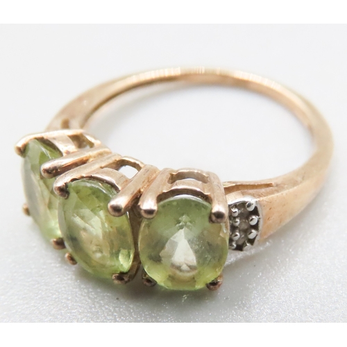 218 - Peridot Three Stone Ring Mounted in 9 Carat Yellow Gold Diamond inset to Shoulders Ring Size J and a... 