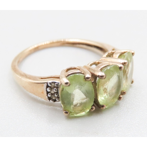 218 - Peridot Three Stone Ring Mounted in 9 Carat Yellow Gold Diamond inset to Shoulders Ring Size J and a... 