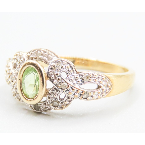 34 - Attractively Detailed Peridot and Diamond Set Ring Mounted in 9 Carat Yellow Gold Ring Size O