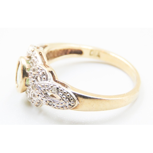 34 - Attractively Detailed Peridot and Diamond Set Ring Mounted in 9 Carat Yellow Gold Ring Size O