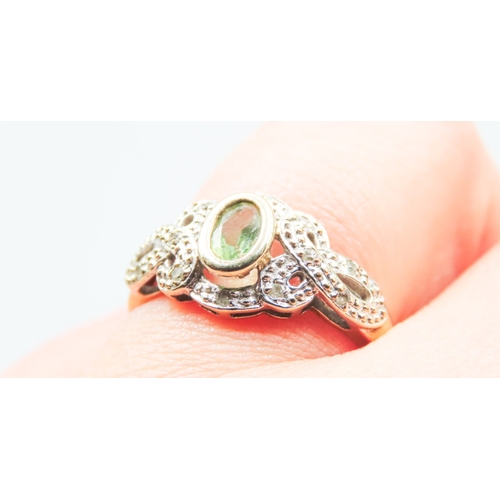 34 - Attractively Detailed Peridot and Diamond Set Ring Mounted in 9 Carat Yellow Gold Ring Size O