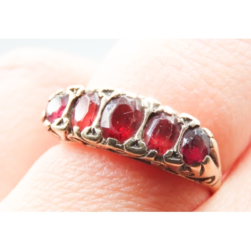 344 - Red Garnet Five Stone Set Ring Mounted in 9 Carat Yellow Gold Ring Size M