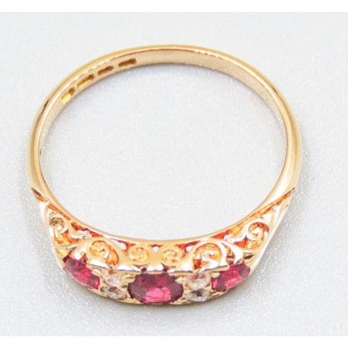 41 - Finely Detailed Ruby Three Stone Ring with Diamond Inset Mounted in 18 Carat Yellow Gold Ring Size O