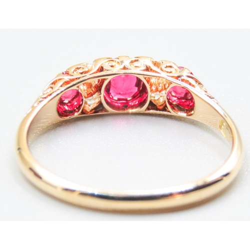 41 - Finely Detailed Ruby Three Stone Ring with Diamond Inset Mounted in 18 Carat Yellow Gold Ring Size O