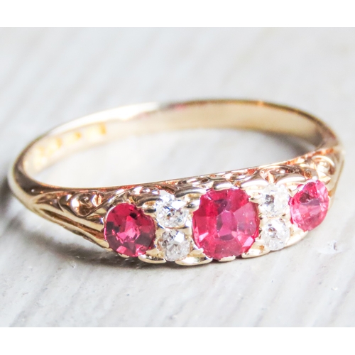 41 - Finely Detailed Ruby Three Stone Ring with Diamond Inset Mounted in 18 Carat Yellow Gold Ring Size O