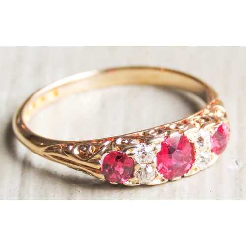 41 - Finely Detailed Ruby Three Stone Ring with Diamond Inset Mounted in 18 Carat Yellow Gold Ring Size O