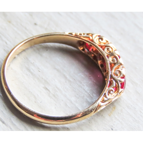 41 - Finely Detailed Ruby Three Stone Ring with Diamond Inset Mounted in 18 Carat Yellow Gold Ring Size O