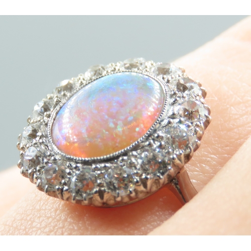 446 - Opal Centre Stone Ring with Fourteen Diamond Set Halo Surround Mounted in Platinum Ring Size P