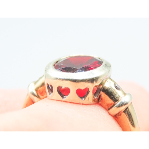 95 - Bezel Set Red Garnet Ring Heart Cut out Motifs Mounted in 9 Carat Yellow Gold Diamond Inset to Shoul... 