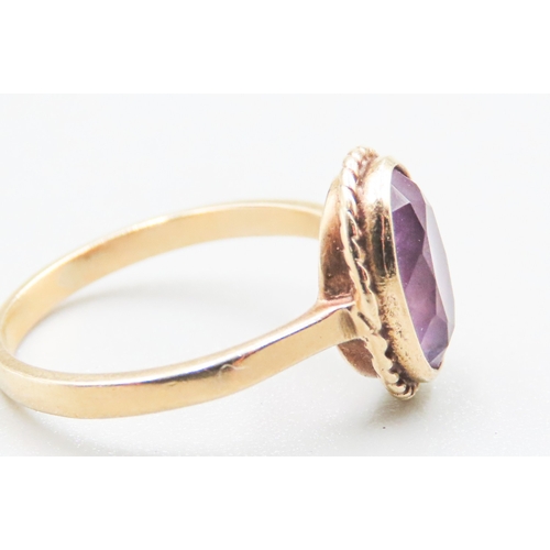 97 - Bezel Set Amethyst Single Stone Ring Mounted in 9 Carat Yellow Gold Ring Size M