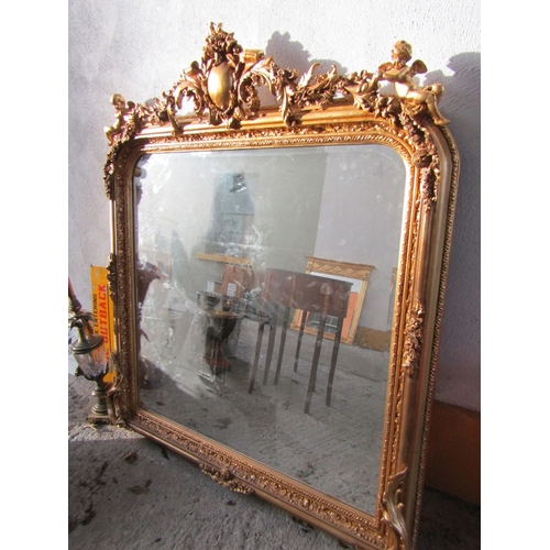 1712 - Gilded Overmantle Mirror with Upper Cherub Motif Decoration Approximately 52 Inches Wide x 58 Inches... 