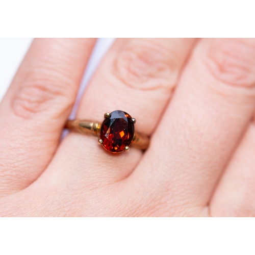 1 - Oval Cut Garnet Set Single Stone Ring Mounted in 9 Carat Yellow Gold Ring Size N and a Half