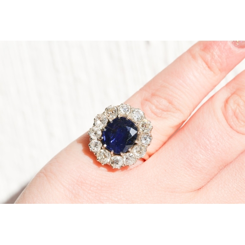 16 - Burmese No Heat Sapphire Centre Stone Ring with Twelve Stone Diamond Set Halo Surround Mounted on 18... 