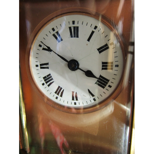 1122 - Oval Form Brass Bound Carriage Clock with Key Attractively Detailed Approximately 5 Inches High