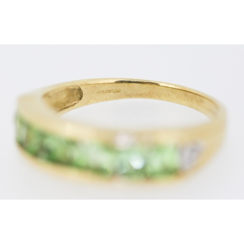 132 - Peridot Seven Stone Ring Channel Set in 9 Carat Yellow Gold Ring Size N