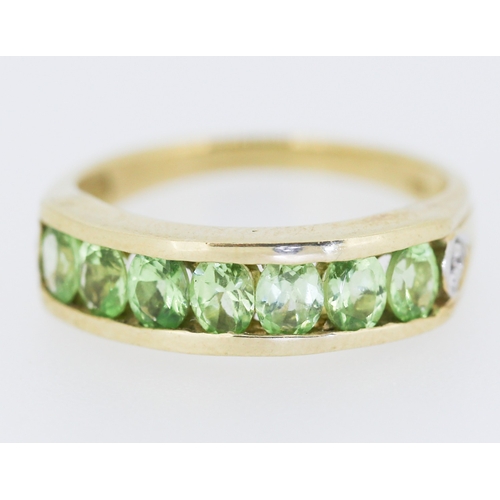 132 - Peridot Seven Stone Ring Channel Set in 9 Carat Yellow Gold Ring Size N