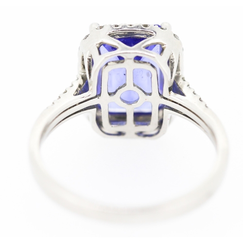 15 - Emerald Cut AAAA Vivid Tanzanite Centre Stone Ring with Diamond Set Halo Surround and Further Diamon... 