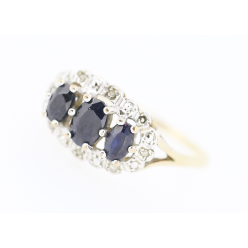 191 - Sapphire Three Stone Ring with Further Diamond Insets Mounted in 9 Carat Yellow Gold Ring Size R