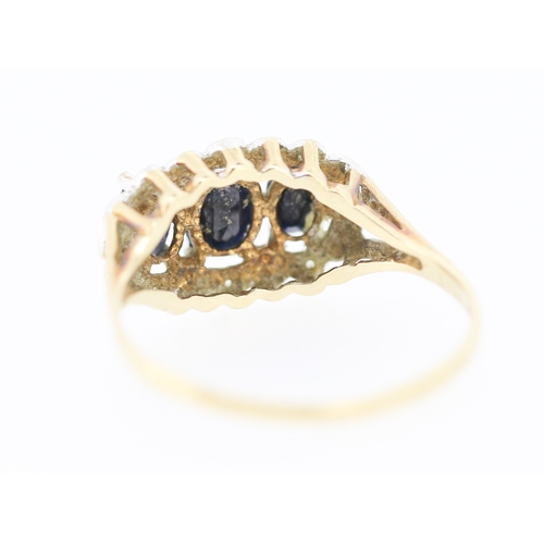 191 - Sapphire Three Stone Ring with Further Diamond Insets Mounted in 9 Carat Yellow Gold Ring Size R