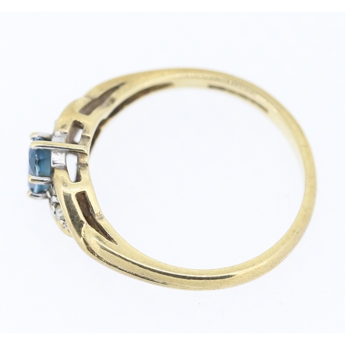 216 - Blue Topaz and Diamond Set Ring Mounted in 9 Carat Yellow Gold Ring Size O