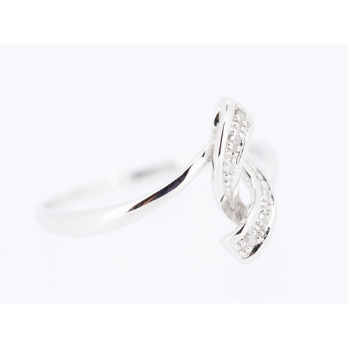 218 - Diamond Set Ribbon Form Ring Mounted in 9 Carat White Gold Ring Size N