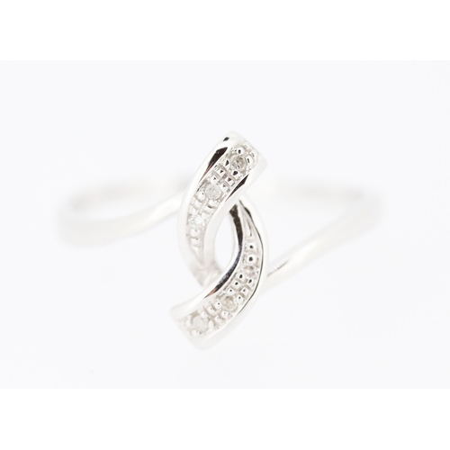 218 - Diamond Set Ribbon Form Ring Mounted in 9 Carat White Gold Ring Size N