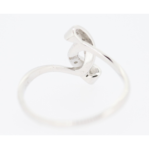 218 - Diamond Set Ribbon Form Ring Mounted in 9 Carat White Gold Ring Size N