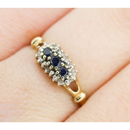 232 - Sapphire Three Stone Ring with Further Diamond Set Surround Mounted in 9 Carat Yellow Gold Ring Size... 