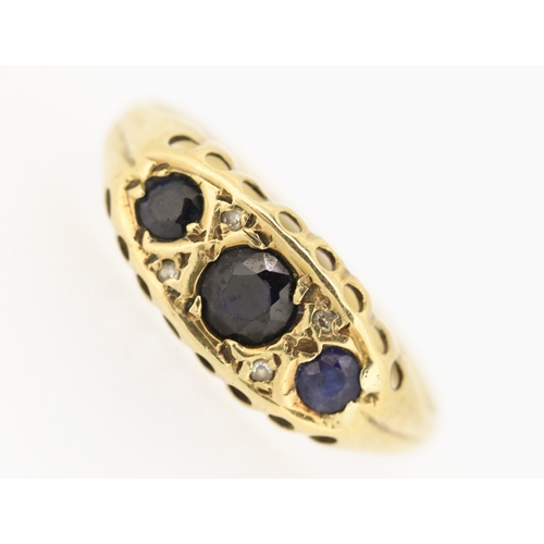 235 - Sapphire Three Stone Ring with Diamond Insets Mounted in 9 Carat Yellow Gold Ring Size N