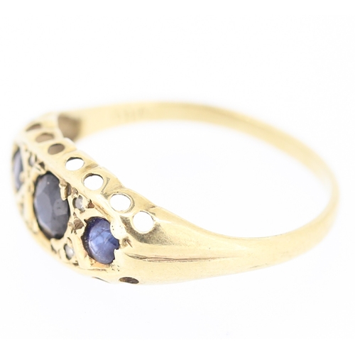 235 - Sapphire Three Stone Ring with Diamond Insets Mounted in 9 Carat Yellow Gold Ring Size N