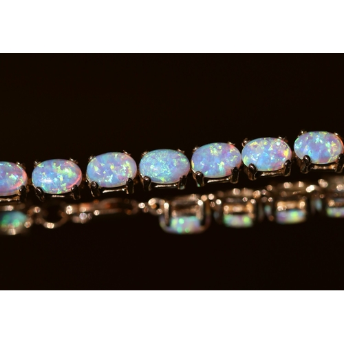 24 - Opal Twenty Two Stone Set Bracelet Mounted in 9 Carat Yellow Gold 18cm Long