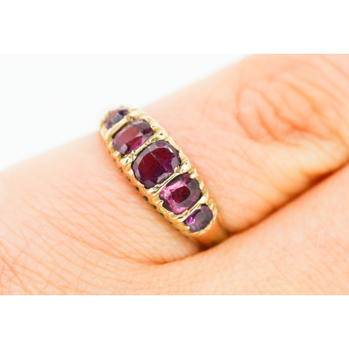 276 - Pink Garnet Five Stone Graduated Form Ring Mounted in 9 Carat Yellow Gold Ring Size M and a Half