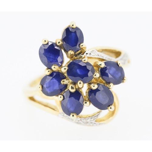 306 - Sapphire Set Seven Stone Floral Form Ring Set in 9 Carat Yellow Gold with Further Diamonds to Settin... 