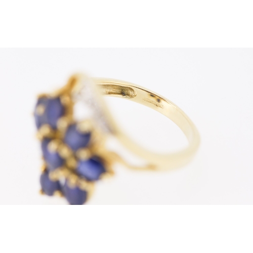 306 - Sapphire Set Seven Stone Floral Form Ring Set in 9 Carat Yellow Gold with Further Diamonds to Settin... 