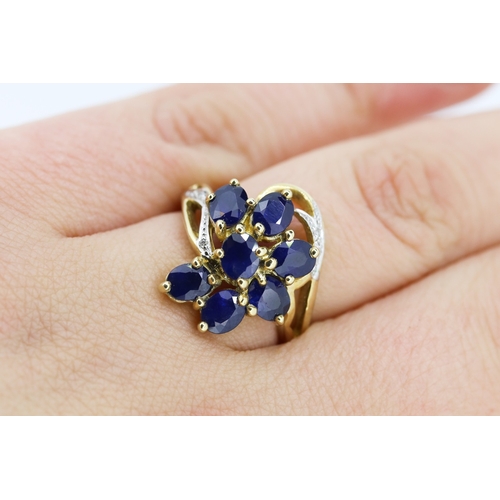 306 - Sapphire Set Seven Stone Floral Form Ring Set in 9 Carat Yellow Gold with Further Diamonds to Settin... 